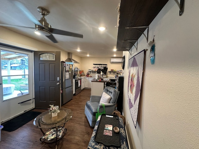 living room featuring a wall mounted air conditioner, dark hardwood / wood-style floors, and ceiling fan