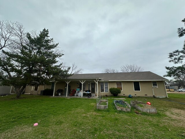 rear view of property with a lawn