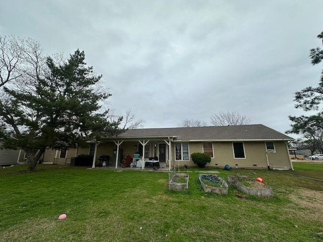 back of property featuring a lawn and a patio