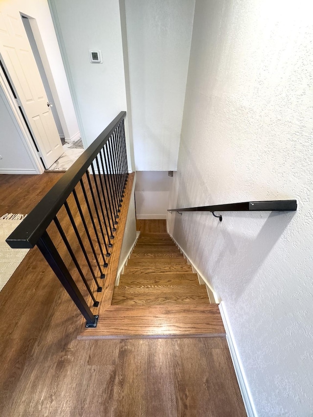 stairs featuring hardwood / wood-style flooring