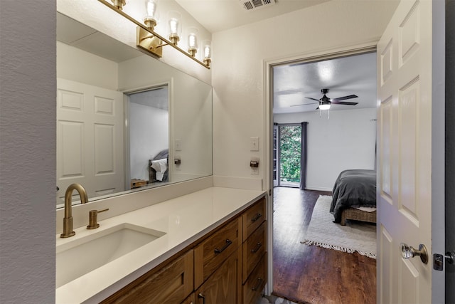 bathroom featuring hardwood / wood-style flooring, vanity, and ceiling fan