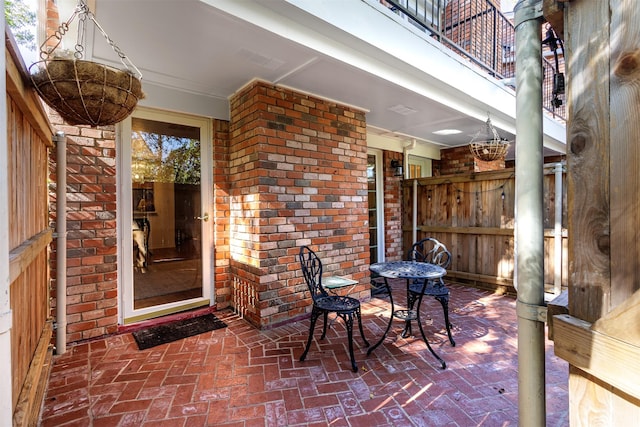 view of patio featuring a balcony