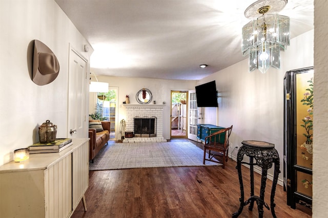 living room with dark hardwood / wood-style floors and a fireplace