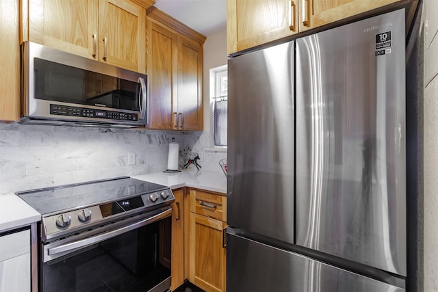 kitchen featuring stainless steel appliances and decorative backsplash