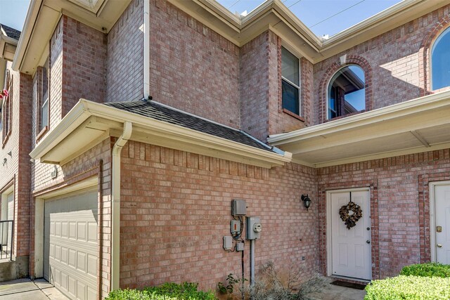 doorway to property with a garage