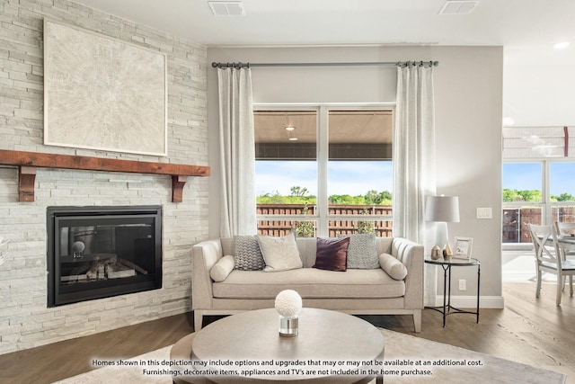 living room with hardwood / wood-style flooring and a fireplace