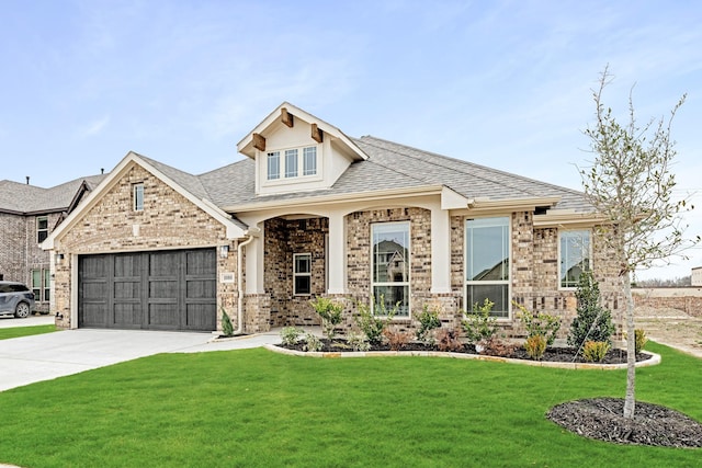 view of front of property featuring driveway, a front lawn, a shingled roof, a garage, and brick siding