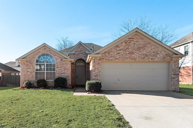 view of front of property with a front yard and a garage