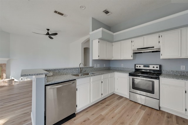 kitchen with white cabinets, sink, light stone countertops, appliances with stainless steel finishes, and kitchen peninsula