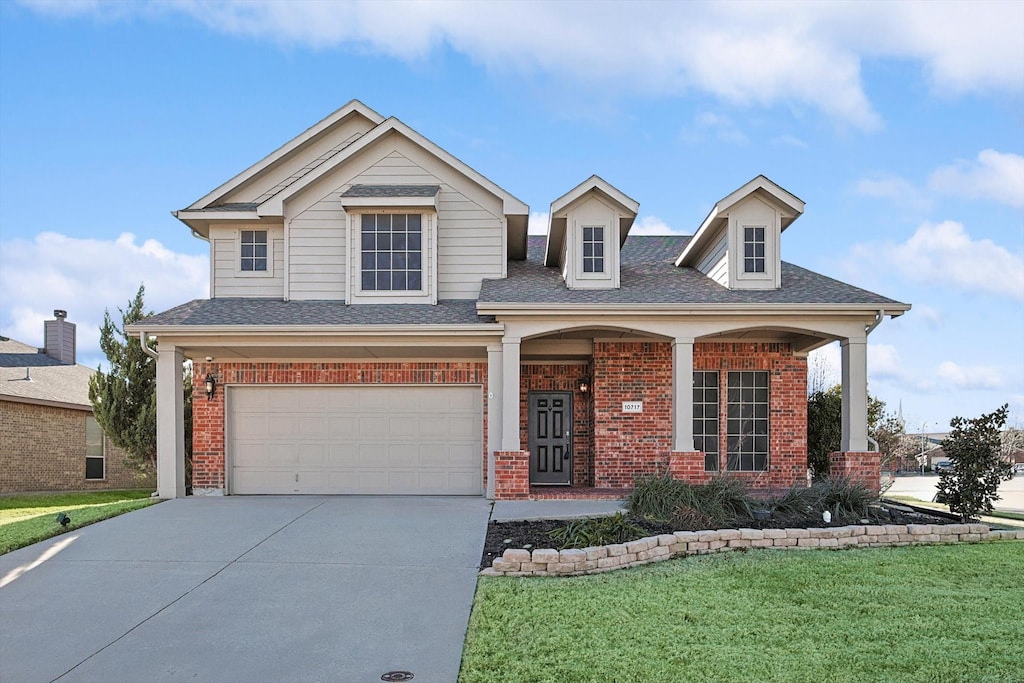 view of front of property with a garage and a front lawn