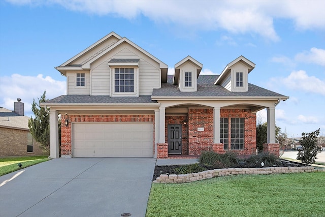 view of front of property with a garage and a front lawn