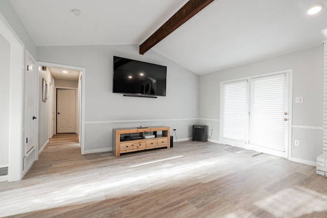 unfurnished living room with vaulted ceiling with beams and light hardwood / wood-style floors