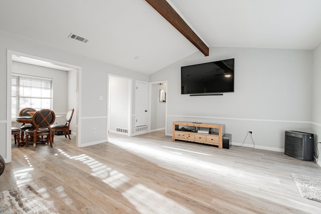 living room with lofted ceiling with beams and light hardwood / wood-style flooring