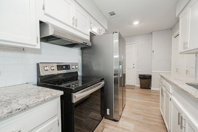 kitchen featuring light stone counters, white cabinetry, stainless steel range with electric cooktop, and light hardwood / wood-style flooring