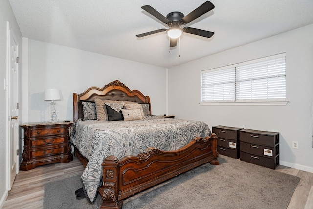 bedroom featuring ceiling fan and light hardwood / wood-style floors