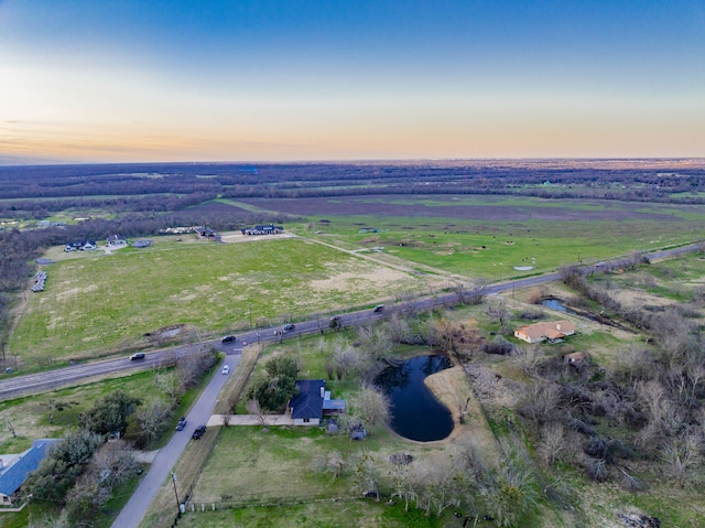 aerial view at dusk featuring a rural view