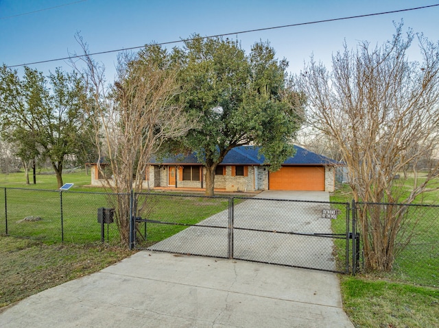 view of front of home with a front yard and a garage