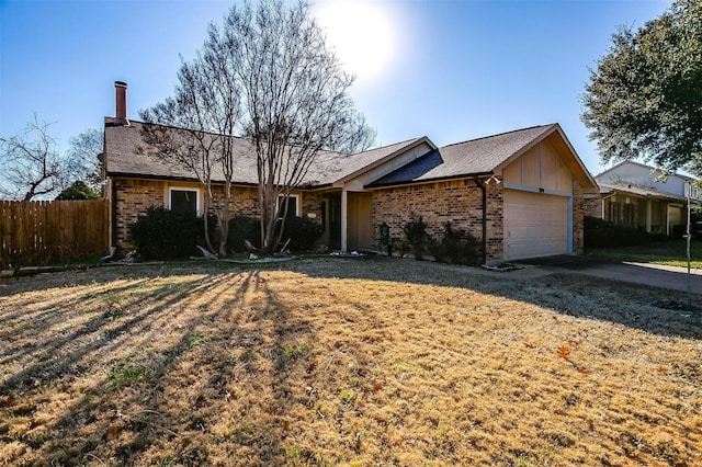 ranch-style home with a garage and a front lawn