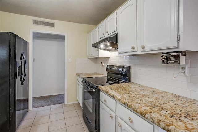 kitchen with white cabinetry, backsplash, light tile patterned floors, black appliances, and light stone countertops