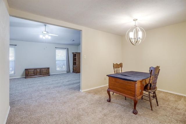 dining room featuring ceiling fan with notable chandelier and carpet flooring