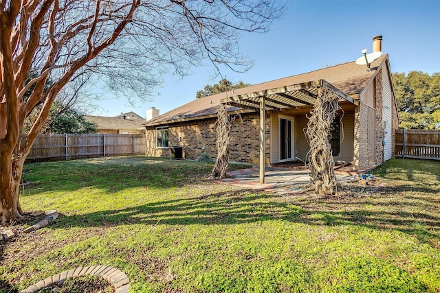 back of house featuring a patio area and a lawn