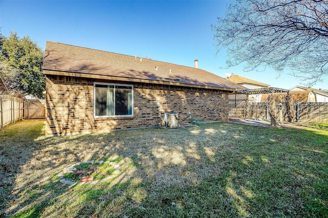 rear view of house with a yard