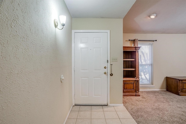 entryway featuring light carpet