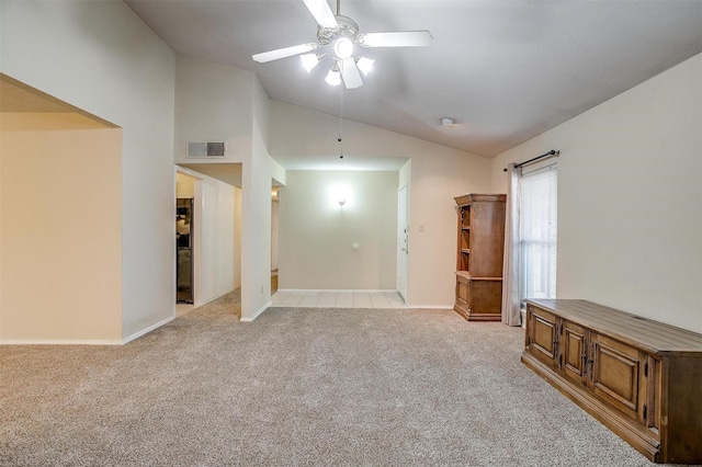 unfurnished living room featuring vaulted ceiling, light colored carpet, and ceiling fan