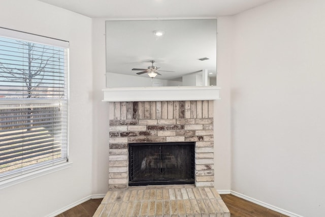 room details featuring hardwood / wood-style flooring, a brick fireplace, and ceiling fan