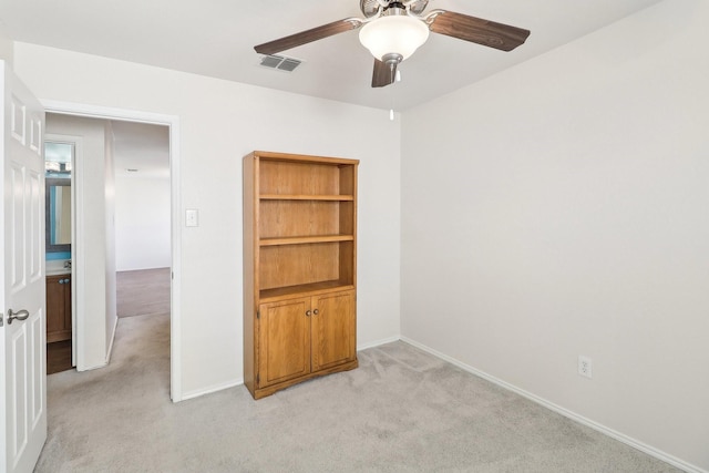 unfurnished room featuring light carpet and ceiling fan