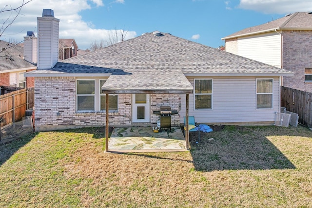 rear view of property with a lawn and a patio area