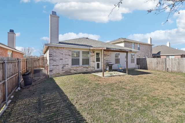 rear view of property with cooling unit, a patio area, and a lawn