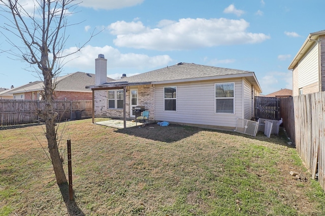 rear view of house featuring a lawn and a patio area