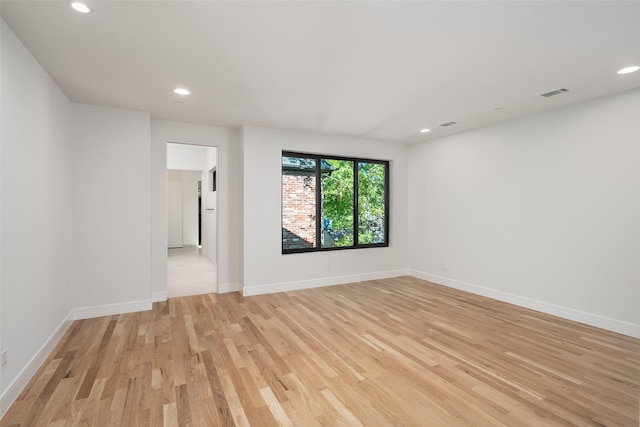 empty room with light hardwood / wood-style flooring