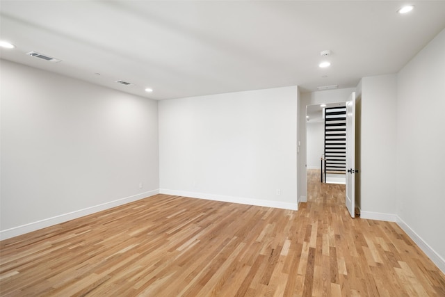 spare room with light hardwood / wood-style flooring