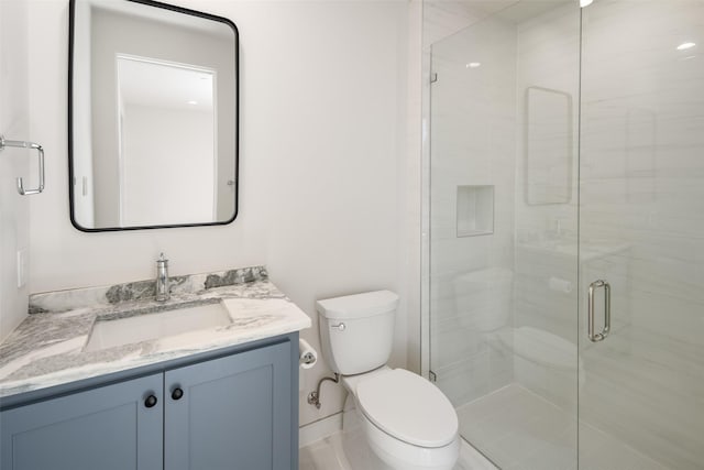 bathroom featuring vanity, toilet, and walk in shower