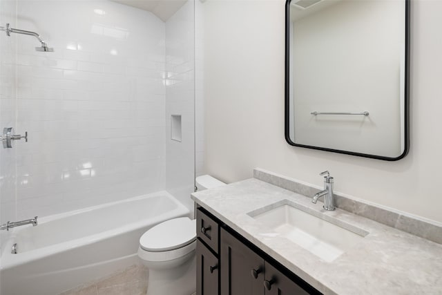 full bathroom with vanity, tiled shower / bath, and toilet