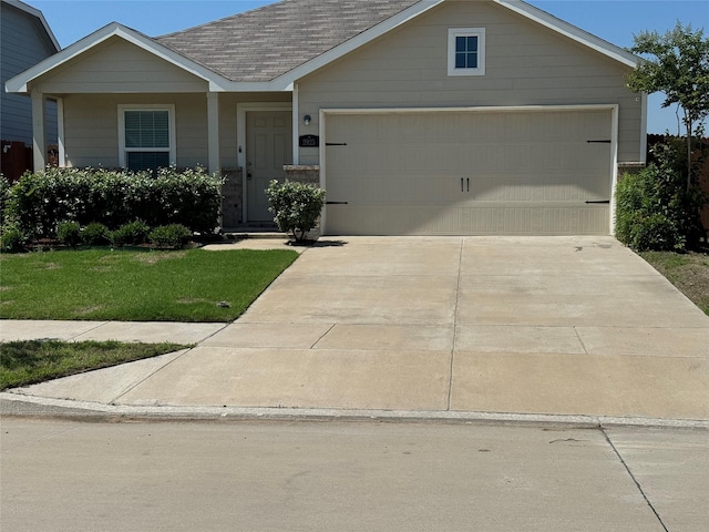 view of front of house with a front yard and a garage