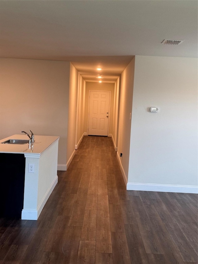 hallway with dark hardwood / wood-style floors and sink