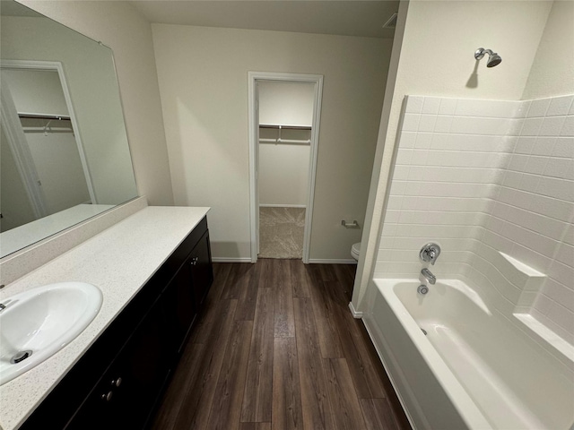 bathroom with toilet, vanity, and hardwood / wood-style flooring