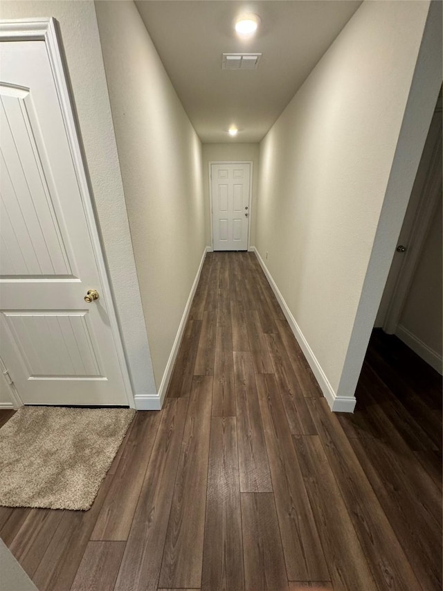 hallway featuring dark wood-type flooring