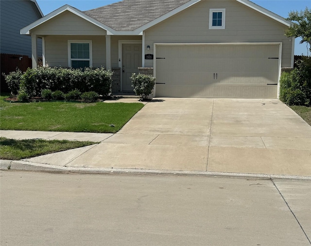 view of front of property with a front yard and a garage