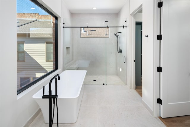 bathroom featuring independent shower and bath