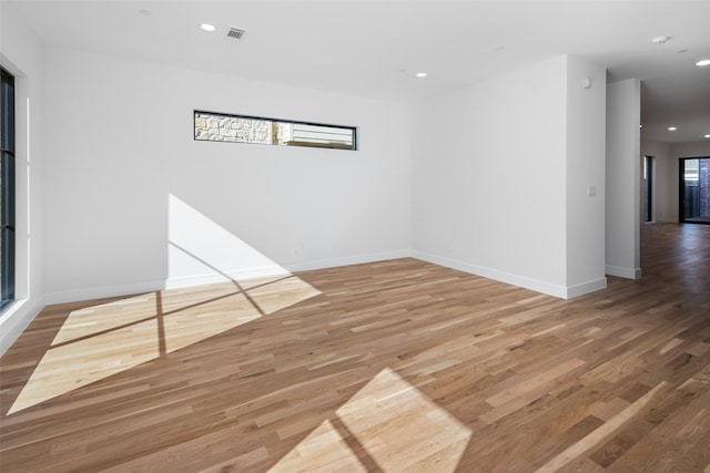 spare room featuring wood-type flooring