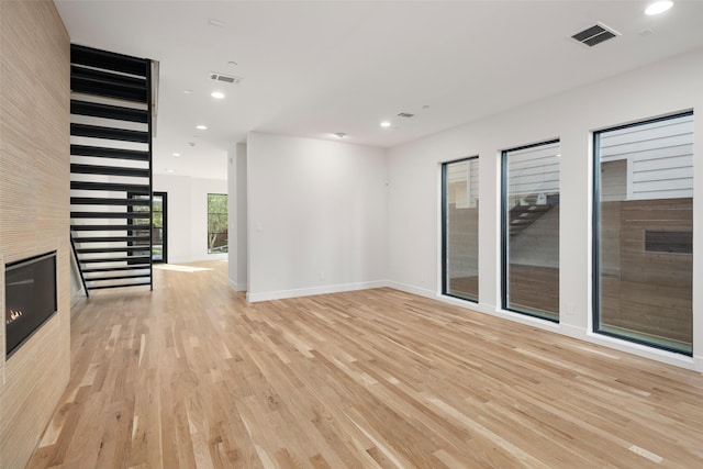 unfurnished living room with light hardwood / wood-style floors