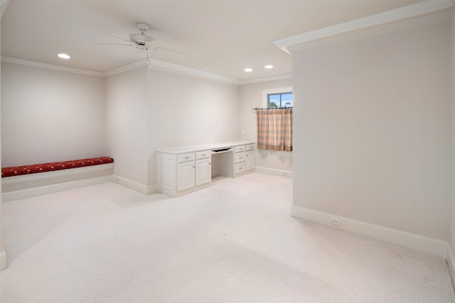 carpeted spare room with ceiling fan and ornamental molding