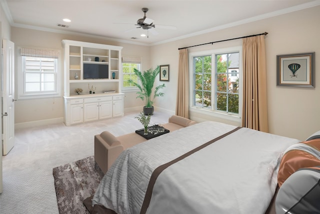 carpeted bedroom featuring ceiling fan and ornamental molding