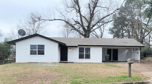 single story home featuring a front yard and brick siding