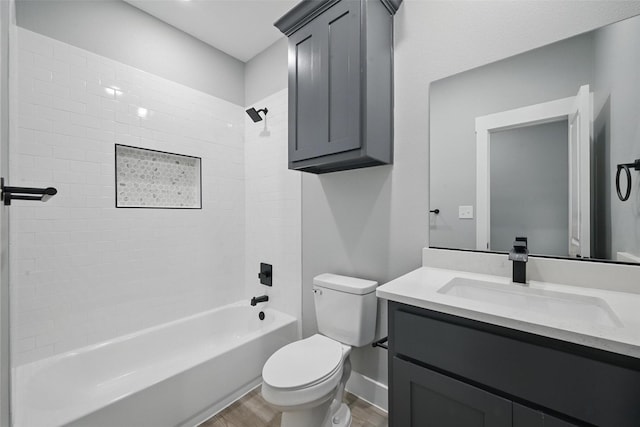 720 W Parnell, Denison, TX 75020 - bathroom featuring wood finished floors, toilet, vanity, bathing tub / shower combination, and baseboards