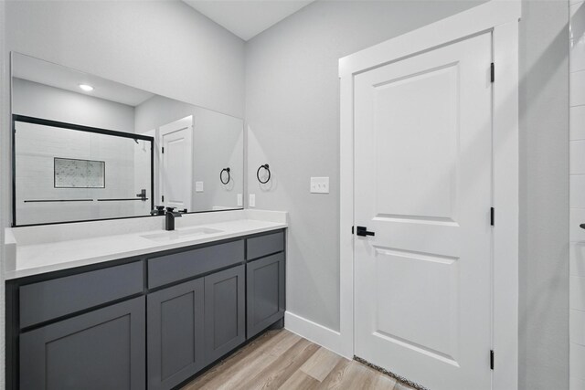 720 W Parnell, Denison, TX 75020 - full bath featuring wood finished floors, baseboards, vanity, and a shower